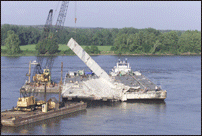 Barge Moving Final Beam Away from Bridge